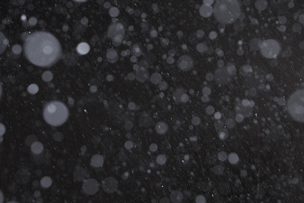 A photograph of snowfall in the night.